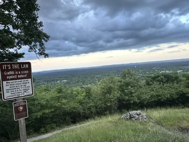 Mountain overlook above Hot Springs with a sign warning against graffiti